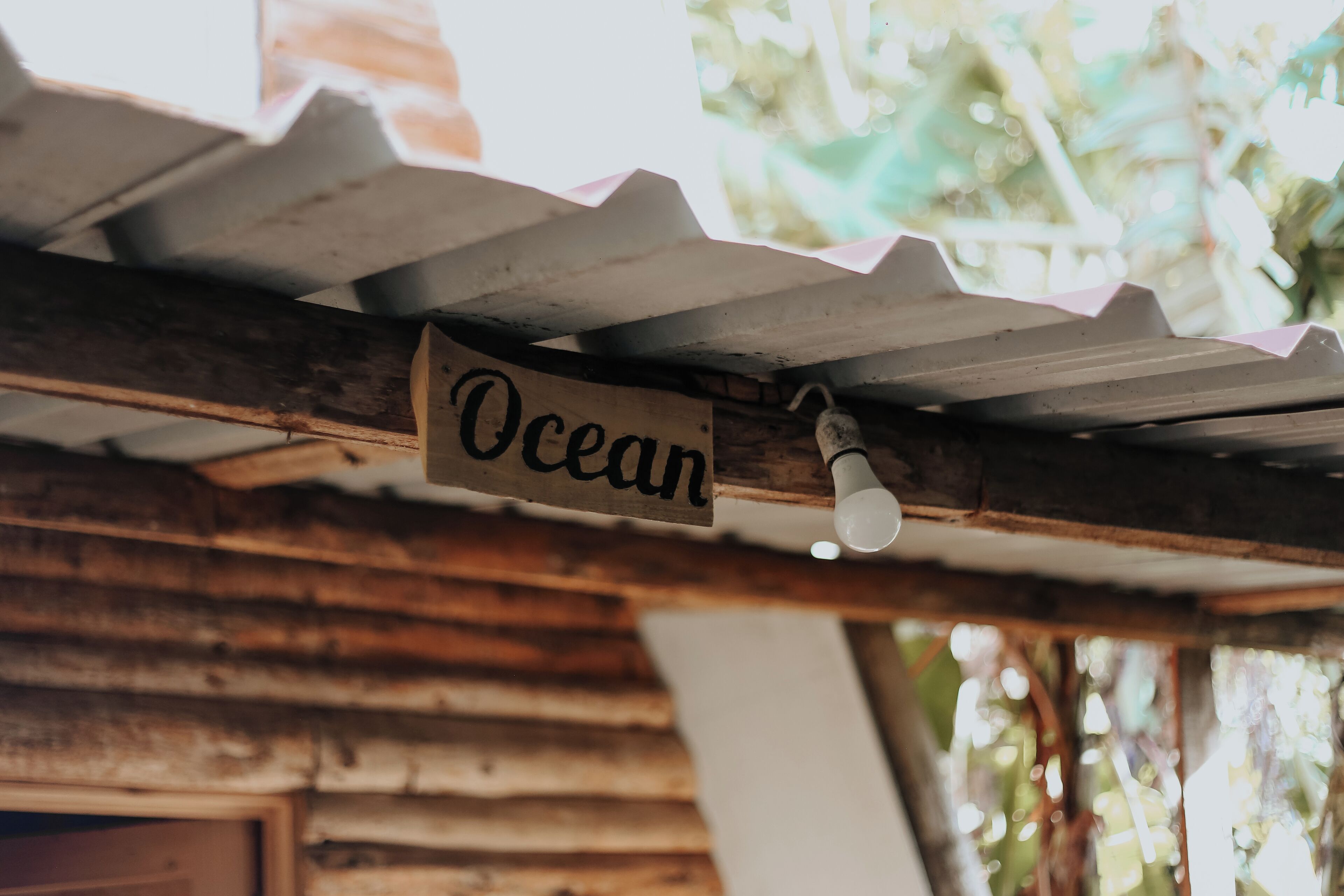 A wooden structure with a corrugated metal roof and a sign that reads "Ocean".
