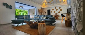 A modern living room with a sofa set, coffee table, and decorative items.