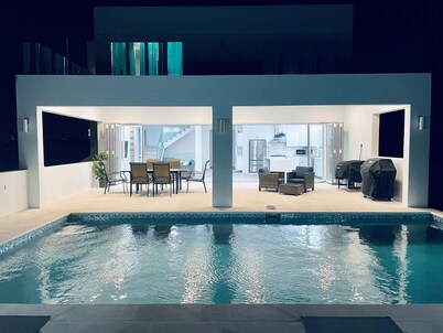 Modern 5-bedroom villa in Long Bay, steps from the beach, with private pool.