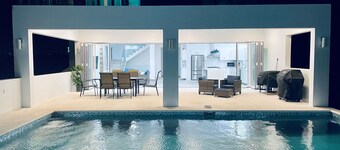 Modern 5-bedroom villa in Long Bay, steps from the beach, with private pool.