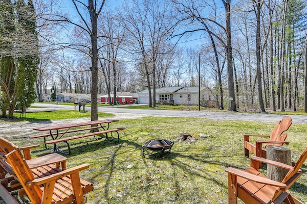 Prudenville Vacation Rental | 2BR | 1BA Exterior | Fire Pit w/ Seating | Hammock