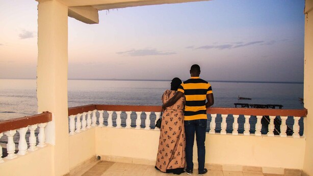 A couple standing on a balcony overlooking a calm sea. - Atlanticoast Residence (Bakau)