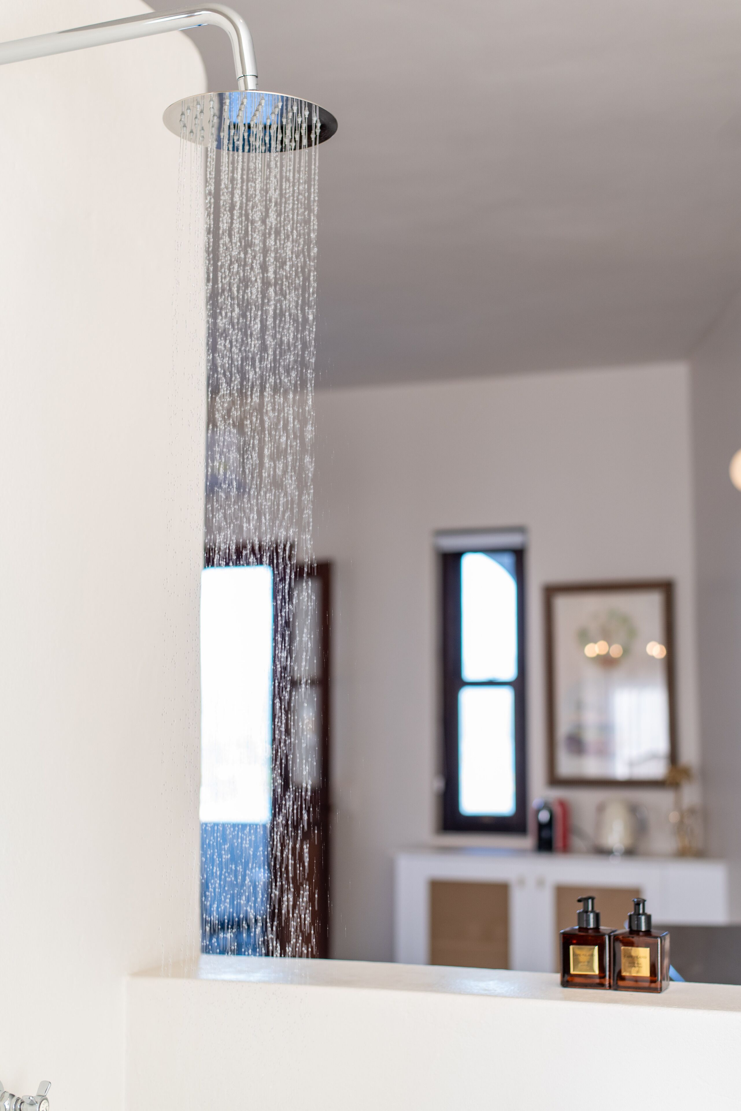A showerhead with water flowing down.