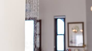 A showerhead with water flowing down.