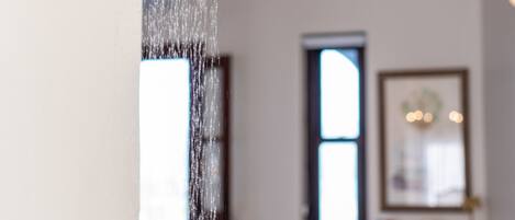 A showerhead with water flowing down.