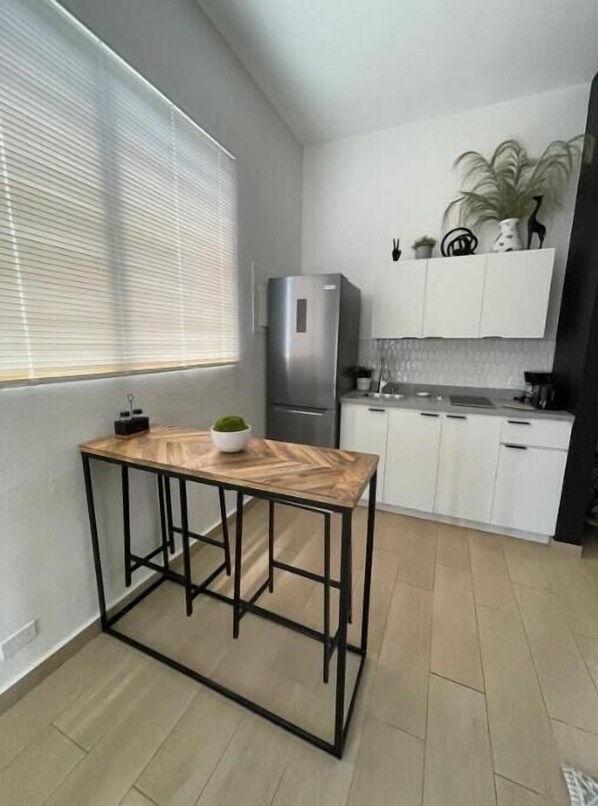 Fridge, microwave, stovetop, coffee/tea maker