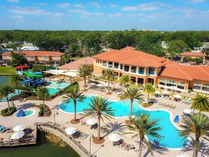 A resort with a large central pool, multiple smaller pools, and a water slide. - Family-Friendly Townhome/September special price! (Kissimmee)