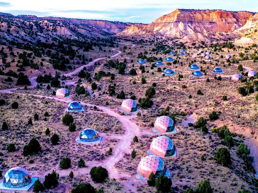 A series of dome-shaped structures in a desert landscape.