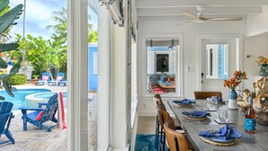 A dining area with a view of a pool and outdoor seating. - Luxury Boating Paradise+Pool+Sailing Kayaks (Marathon)