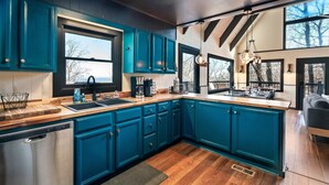 A kitchen with teal cabinets, wooden countertops, and a built-in dishwasher. - Free Dollywood Tix/Views/Pool/Dog Friendly/Private (Gatlinburg)