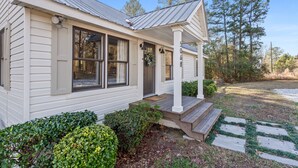 A single-story house with a front porch, a mailbox, and a number '5068' on the door. - Cook Cottage (Stockbridge)