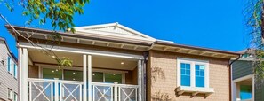 A two-story house with a front porch, a garage, and a small attached garage.
