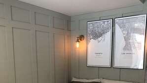 A bedroom with a bed, two framed maps, and a wall-mounted light fixture. - Modern private suite in Vaughan (Vaughan)