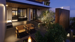 A modern house with a patio, outdoor seating, and a fire pit. - NOT A HOTEL AOSHIMA (Miyazaki)