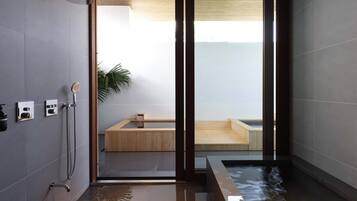 Enjoy a spa-like experience in this bathroom with a glass-enclosed shower and a bathtub.