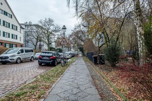 Stroll through a charming urban neighborhood lined with historic buildings and picturesque trees.