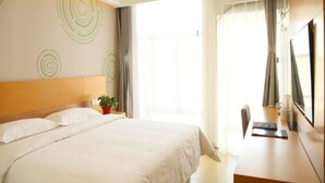 A hotel room with a bed, a desk, a chair, a potted plant, and a large window. - Greentree Inn Beijing Fengtai District Changxindian Express Hotel (Beijing)