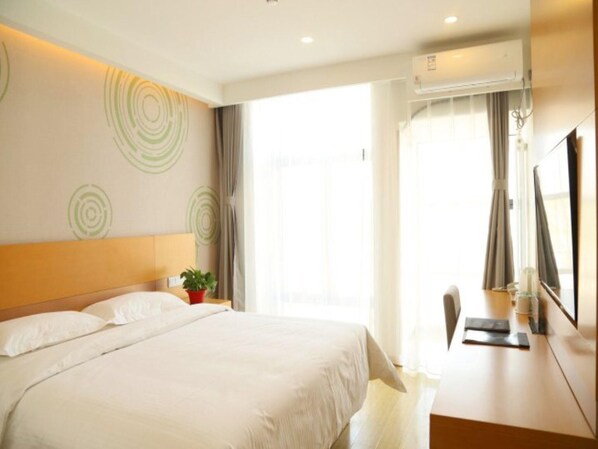A hotel room with a bed, a desk, a chair, a potted plant, and a large window. - Greentree Inn Beijing Fengtai District Changxindian Express Hotel (Beijing)