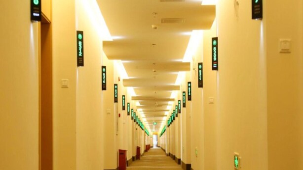 A long, well-lit hallway with directional signs on the walls. - Greentree Inn Beijing Fengtai District Changxindian Express Hotel (Beijing)