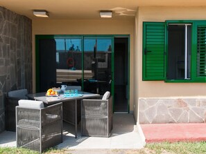 Enjoy al fresco dining on the patio with a table, chairs, and refreshing amenities.