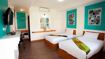 A hotel room with two beds, a desk, a chair, a television, and a mirror.