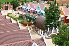 A model of a fantasy-themed resort with colorful buildings, a central lawn area, and a swimming pool. - Fantasy Resort Chainat (Chai Nat)