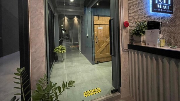 A hotel entrance with a reception desk, a 'LOFT SPACE' sign, a 'STAFF ONLY' door, and a hallway leading to the interior. - Loft Space Hotel (Ranong)