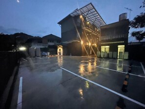 A building with a modern design, featuring a glass facade and a ramp leading to the entrance. - Loft Space Hotel (Ranong)