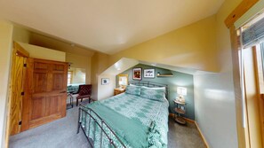 A bedroom with a bed, a chair, a desk, and a window. - Coyote Run - 4 (Moab)