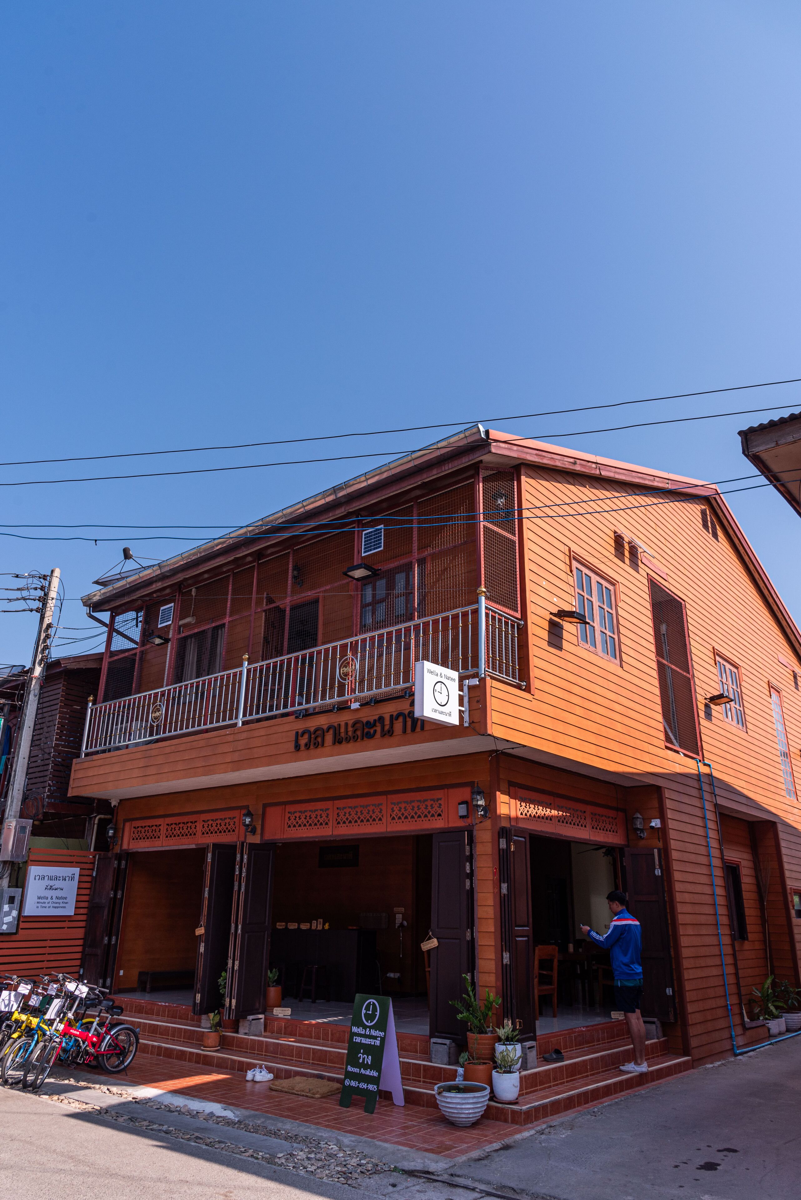 A two-story building with a balcony and a sign indicating a restaurant.