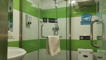 A bathroom with a glass shower enclosure, a sink, and a toilet.