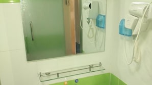 A bathroom with a white sink, a mirror, and a hairdryer on the wall. - 7 Days Inn Changzhi Qin County (Changzhi)