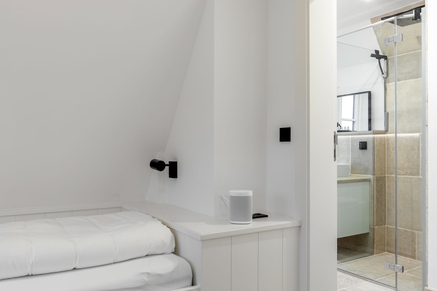 A modern bathroom with a shower, a toilet, and a sink.