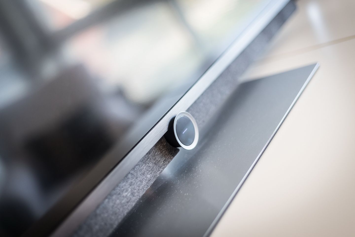 A close-up of a window blind with a central pull cord.