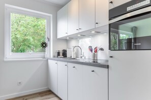 Fridge, stovetop, dishwasher, coffee/tea maker