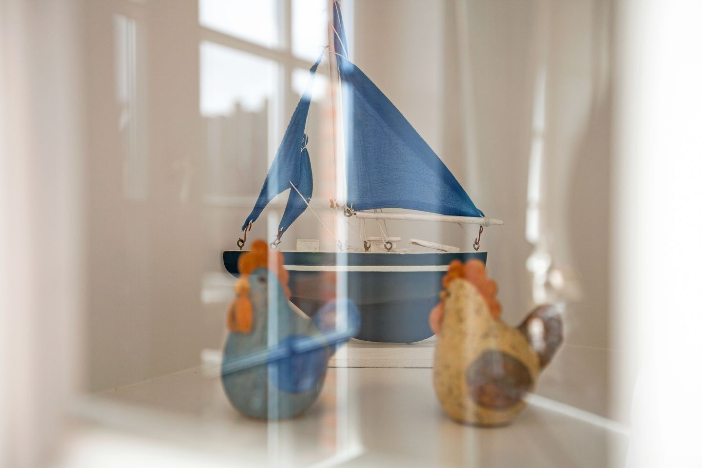 A model sailboat in a glass display case.