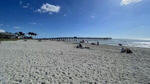 A beach with a pier extending into the ocean, sandy beach, and clear blue sky. - New Beach Cabana with Mini Golf (Venice)