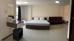 A bedroom with a bed, a desk, a chair, and a mirror. - My Room Nakhonpathom (Nakhon Pathom)