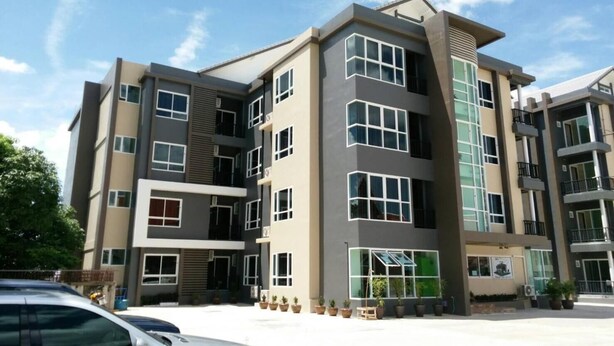 A multi-story building with a modern architectural design, featuring large windows and balconies. - My Room Nakhonpathom (Nakhon Pathom)