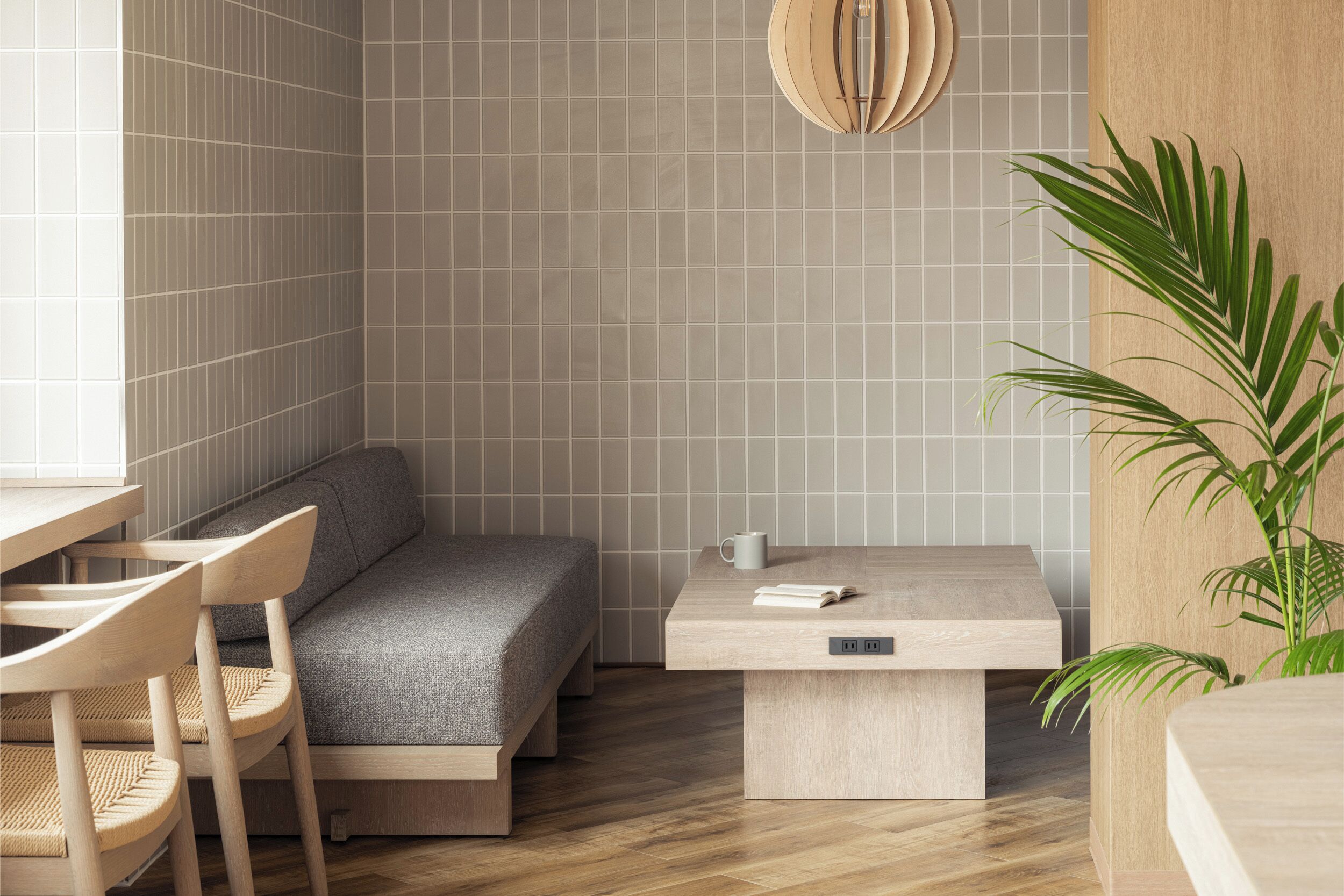 A modern, compact room with a bed, a small table, and a chair.