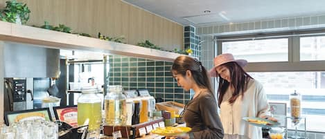 A buffet setup with various food items and a coffee machine.