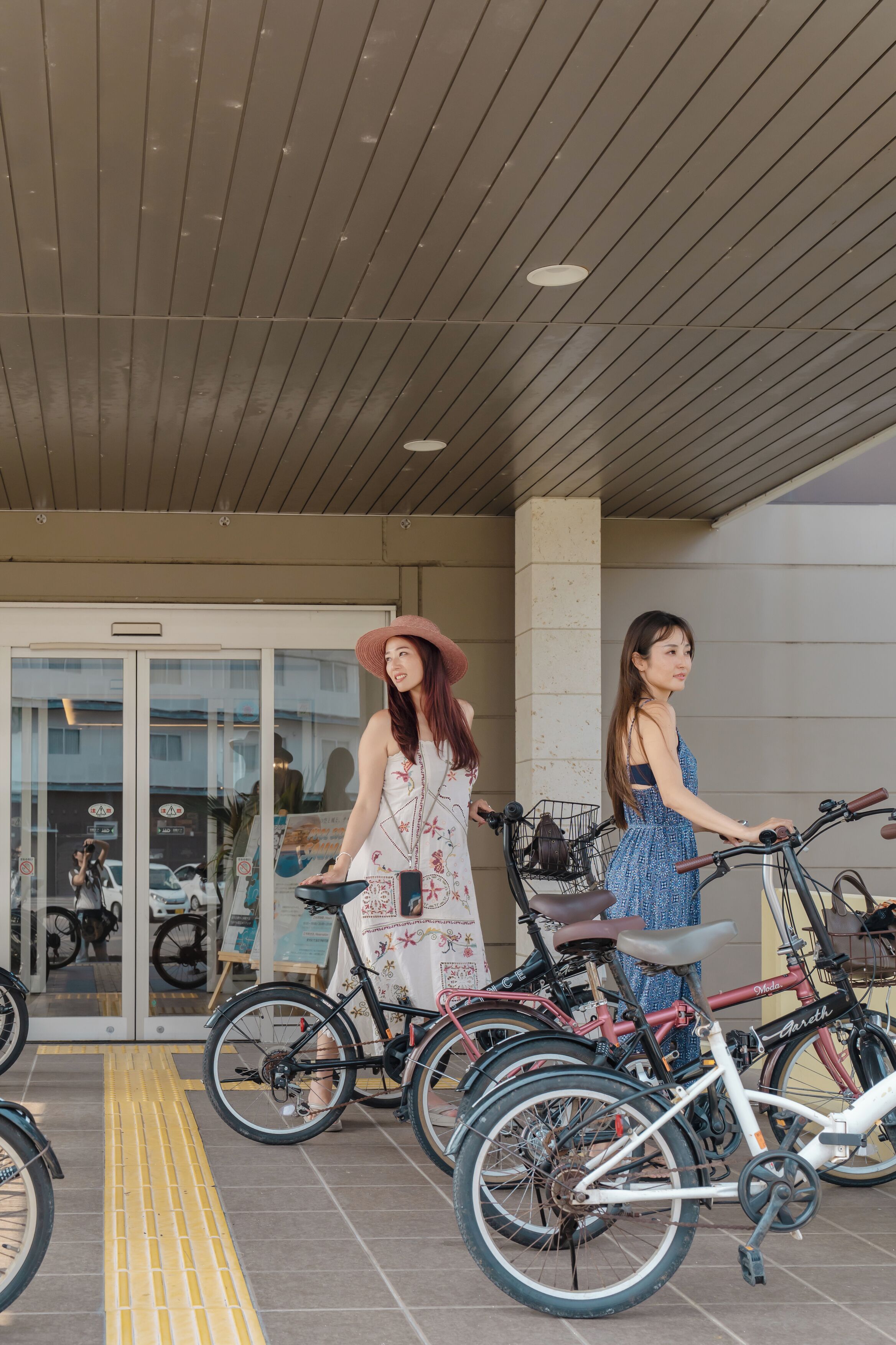 A covered entrance with bicycles parked outside.