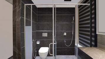 Un baño moderno con ducha acristalada, inodoro y lavamanos.
