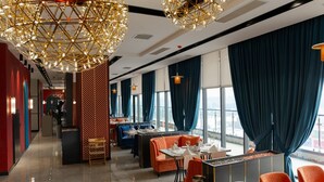 A modern hotel lobby with seating areas, a reception desk, and large windows with curtains. - Park Dedeman Almaty (Almaty)