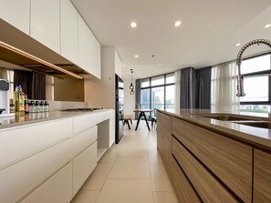 Enjoy cooking in this well-equipped kitchen with a central island, oven, and range hood.
