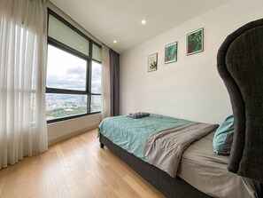 Enjoy a city view from the comfort of this stylish bedroom with a single bed, framed artwork, and natural light.