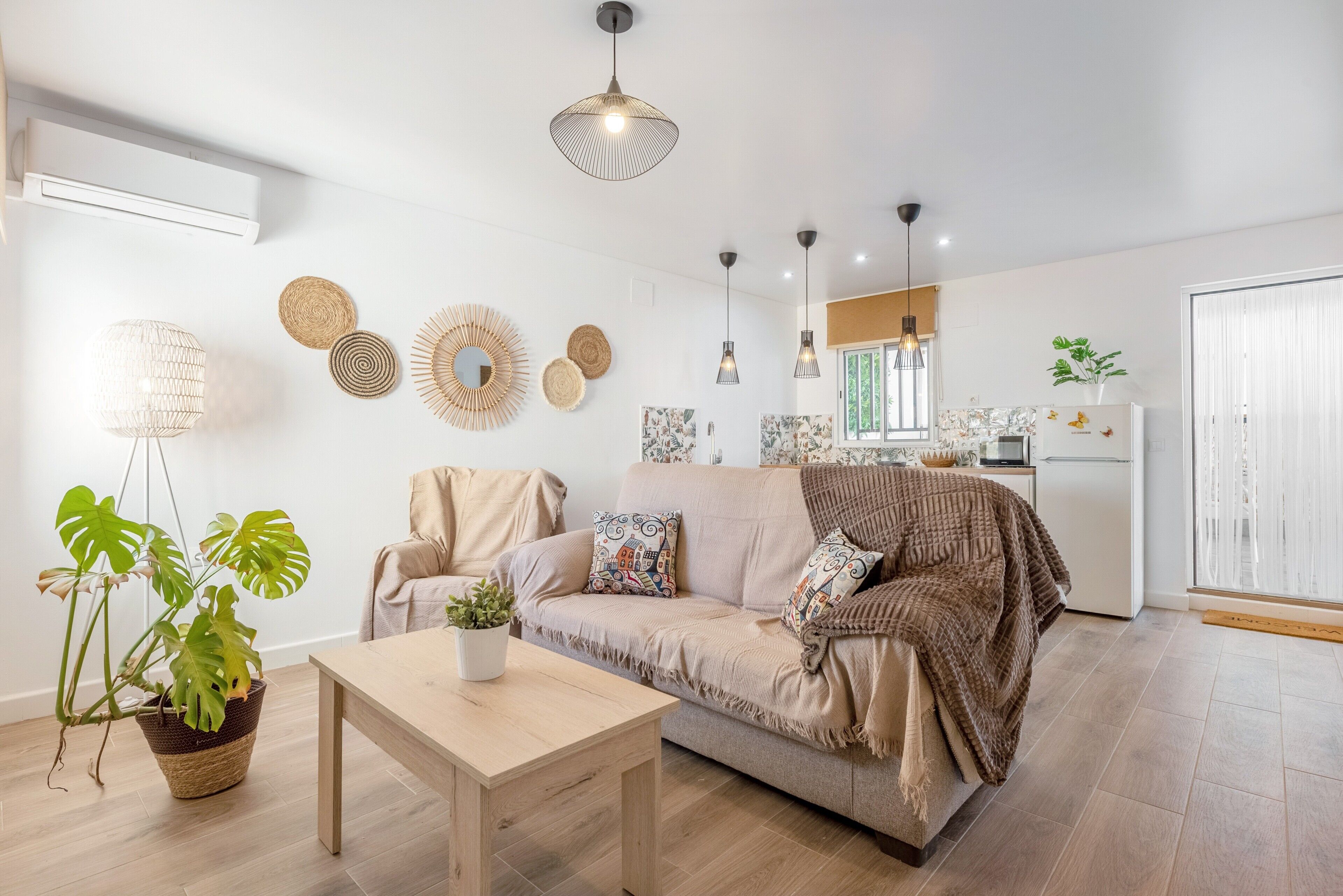 A modern living room with a sofa, a coffee table, and a potted plant.