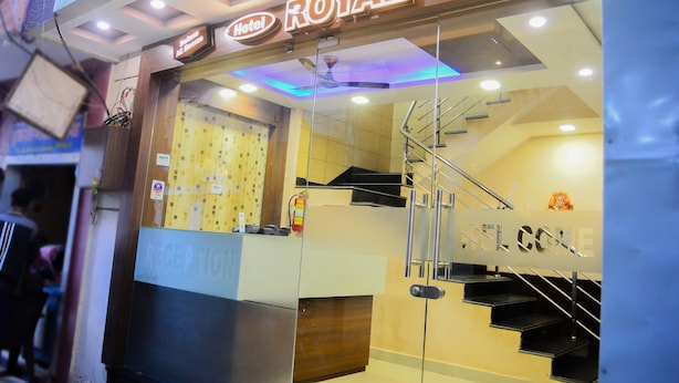 A hotel entrance with a reception desk, a staircase, and a sign that reads "ROYAL Palace Hotel". - Hotel Royal Palace (Ujjain)