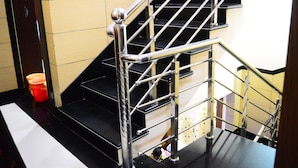 A staircase with metal railings and black steps. - Hotel Royal Palace (Ujjain)