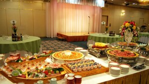 A buffet setup with various food items and drinks.